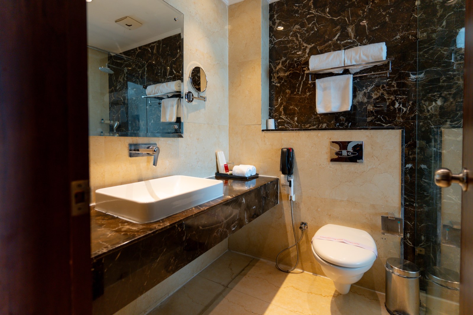 Executive Room: The bathroom in dark marble, vessel basin and walk-in shower