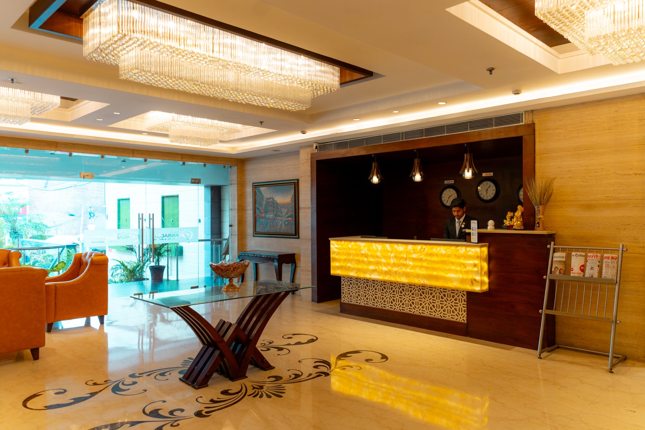 The lobby at night, the lit reception and the glass entrance