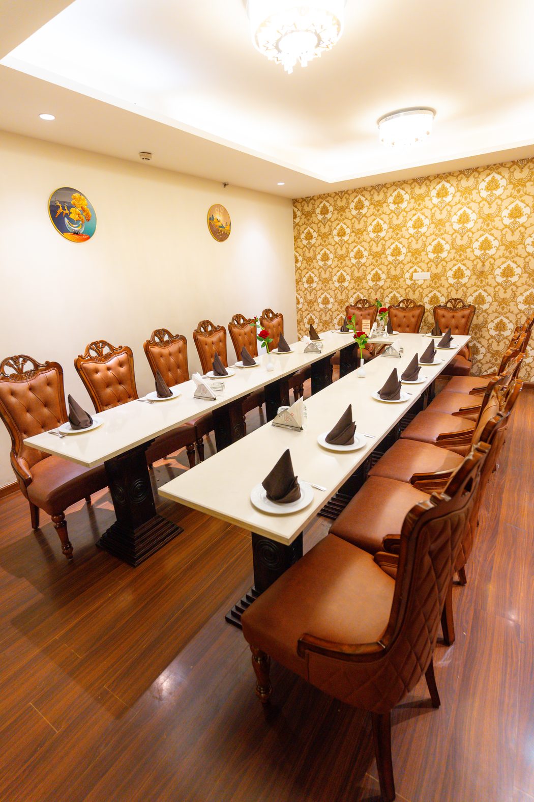 A private dining room, the long table laid under the chandelier