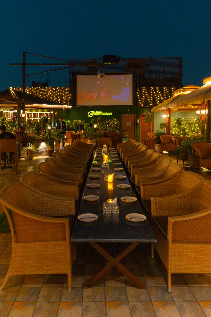 The terrace laid as one long table at night