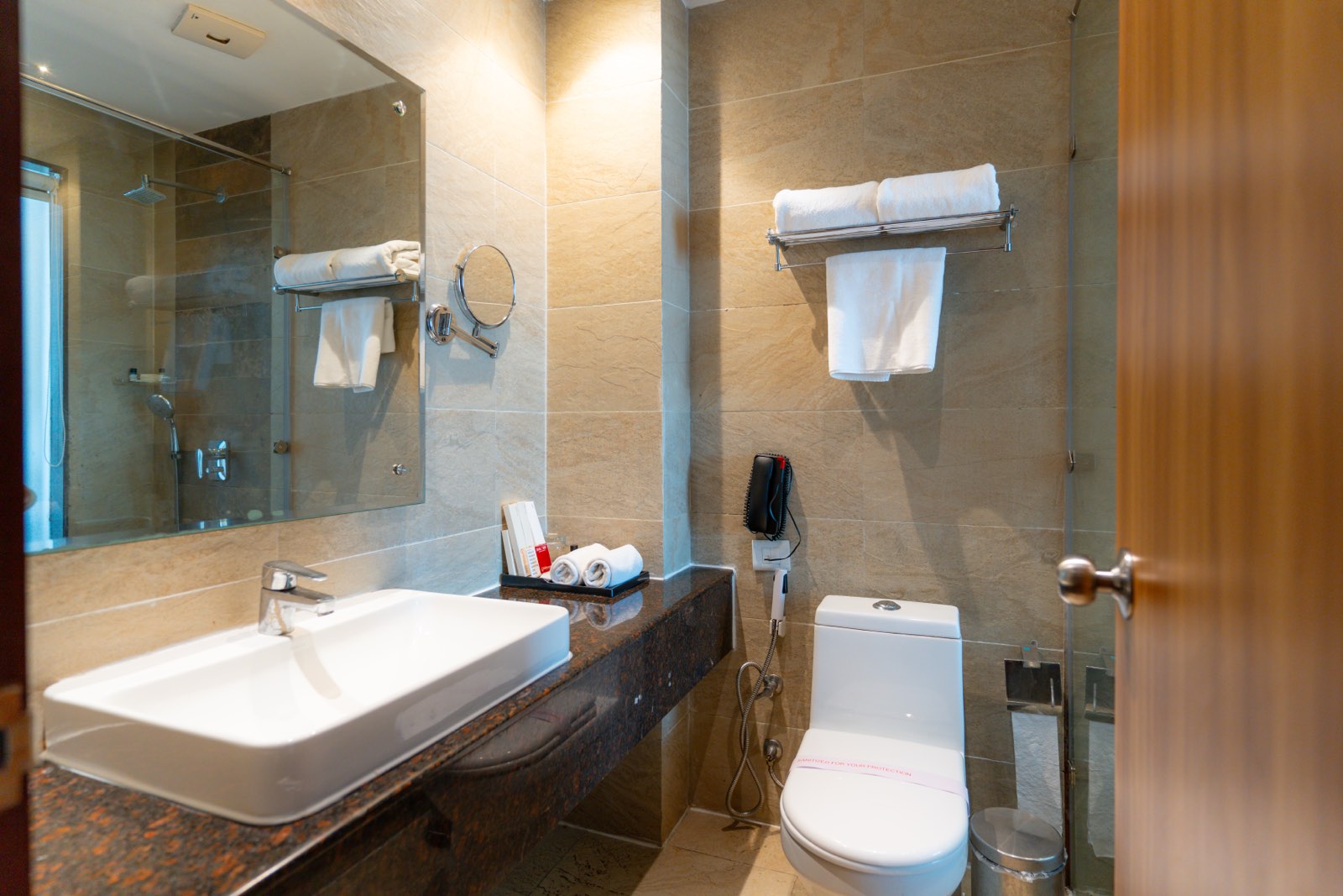 Twin Room: The bathroom, basin and mirror with towels on the rail